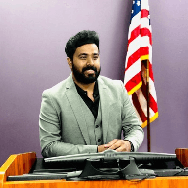 Harish Dasoju wearing a gray suit.